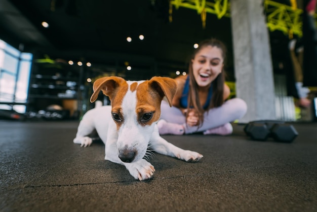 Leuke jack russell-hond in de sportschool met haar baasje