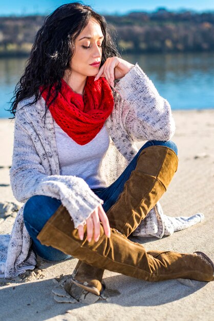 Leuke jonge vrouw op het strand in de winter