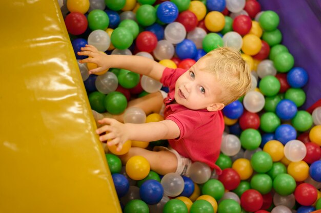 Foto leuke jongen die van ballenbak geniet