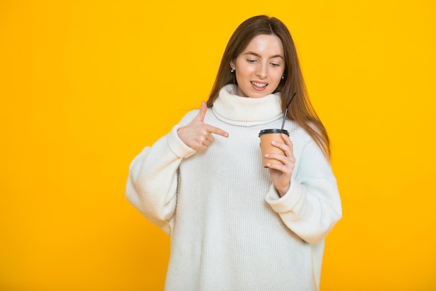 Leuke mooie jonge vrouw over gele achtergrond