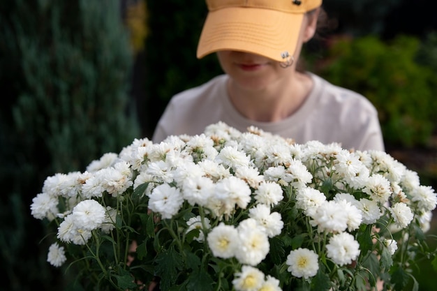 Leuke vrouw met witte bloemen in de tuin