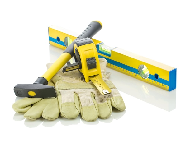 Level, tapeline, hammer and gloves