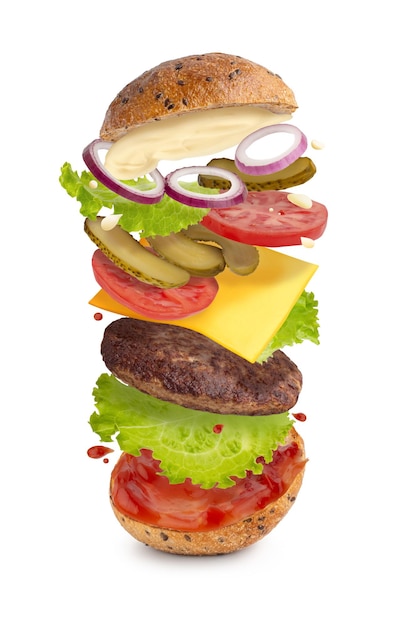 levitating burger with beef and vegetables on a white isolated background