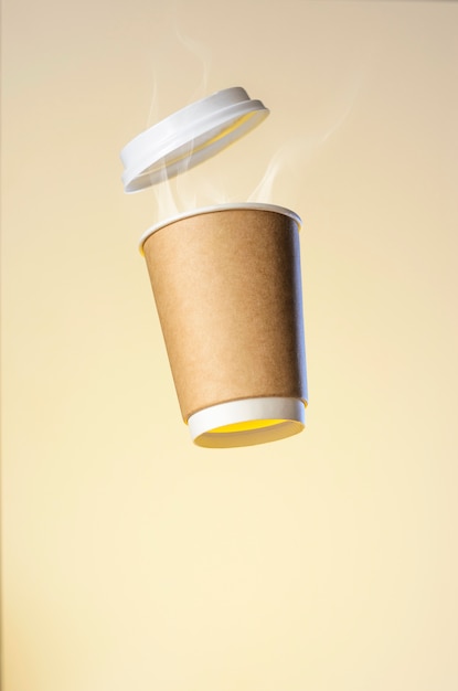 Levitating paper cup with hot coffee