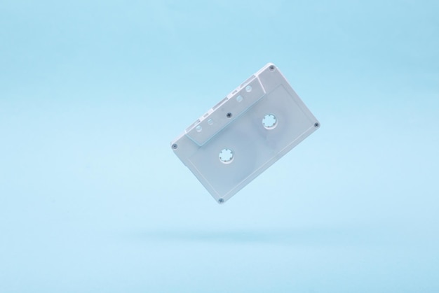 Photo levitating white audio cassette on blue background 3d photo minimalistic still life creative layout concept art