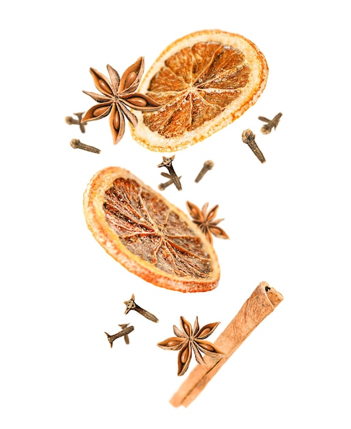 Levitation of anise cinnamon dried orange and cinnamon on a white isolated background