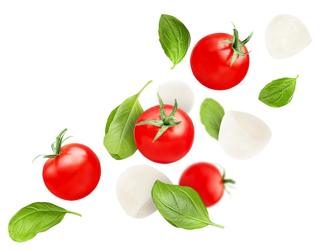 Levitation of cherry tomatoes basil leaves and mozzarella on a white isolated background