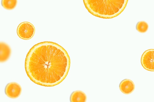 Levitation of orange slices on a light background with space for text An image with selective focusing