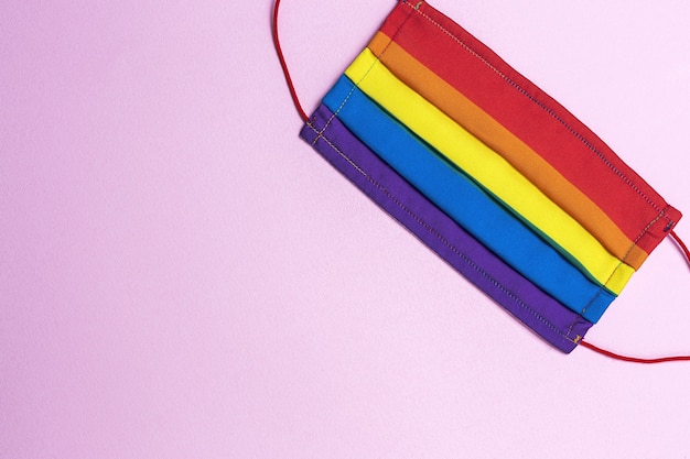 Photo lgbt background with rainbow colored protective face mask from above. flat lay. covid-19 virus