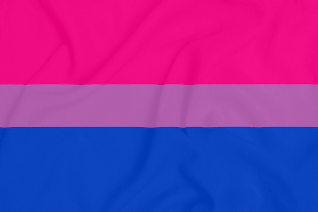 Photo lgbt bisexual pride community flag on a textured fabric. pride symbol