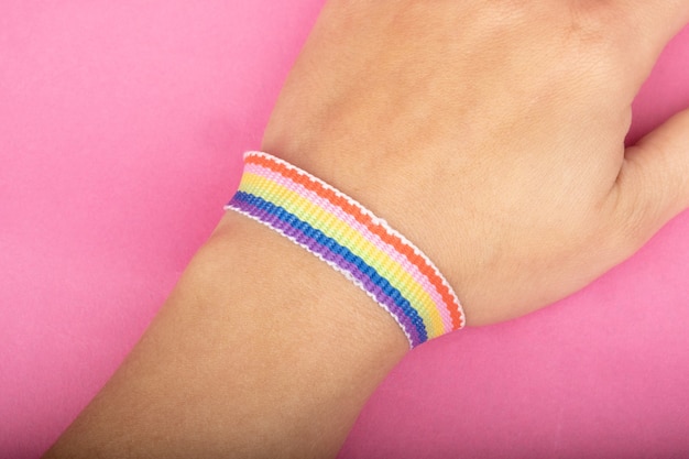 Lgbt community support feed lgbt ribbon in hand on pink background