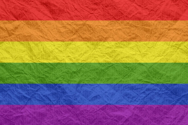 Photo lgbt flag on old crumpled craft paper textured background wallpaper for design