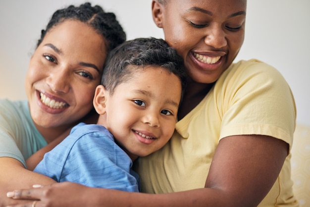LGBT hug and face of family portrait happy kid and mothers love affection and enjoy bonding time together Home closeup and gay people non binary parents or lesbian women embrace adoption child