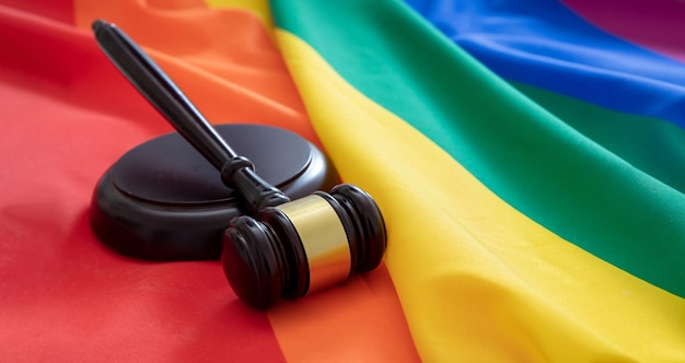 Lgbt law gay marriage judge gavel on rainbow color textile close up transgender rights