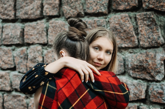 Lgbt lesbisch koppel liefdesmomenten concept twee jonge lesbiennes meisjes knuffelen en wandelen buitenshuis gelukkig