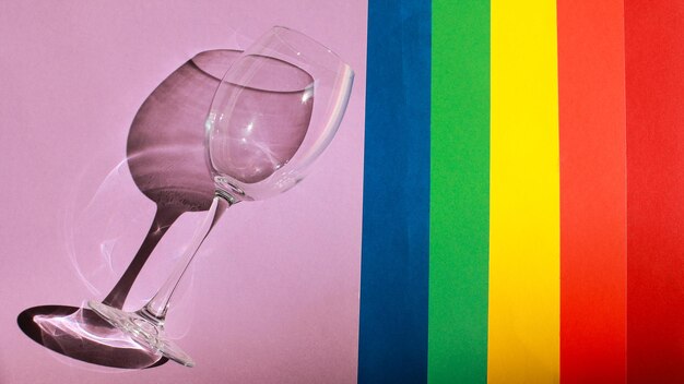 Lgbt pride flag with a glass colored paper backgrounds are laid\
out in lgbt flag colors celebration concept