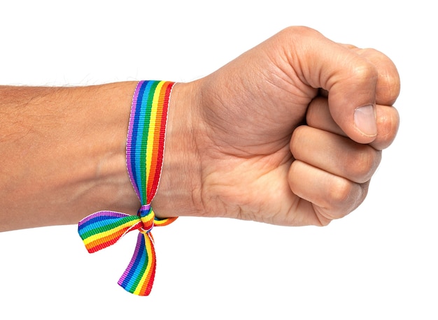 Photo lgbt rainbow ribbon on hand with fist. isolated on white background.