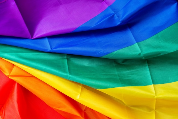 LGBTQ flag and symbol on table top view