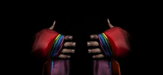 Lgbtq pride flag on black background lgbt rainbow flag in gay\
hand