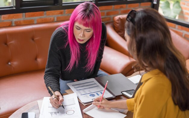 LGBTQ transgender man Beautiful Authentic Specialist with Pink Hair and Nonbinary trans working together Working Design in creative workplace team work colleagues Gender equality