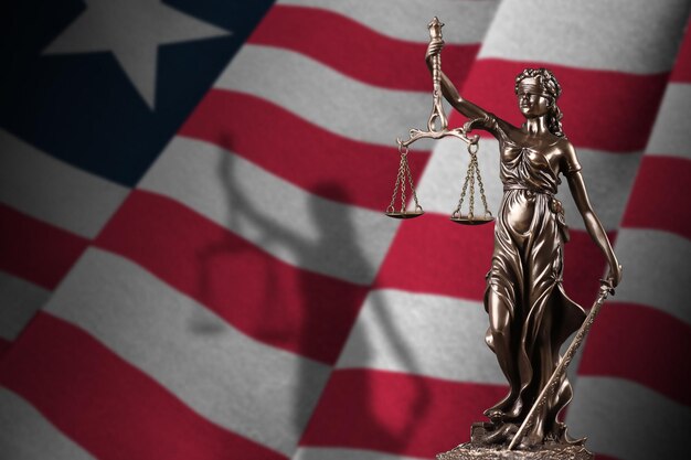 Liberia flag with statue of lady justice and judicial scales in dark room Concept of judgement and punishment