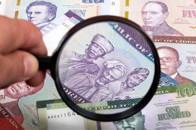 Liberian money in a magnifying glass a business background