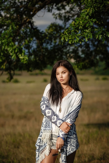 Liberty peace of mind concept. Attractive young woman is walking in field. She is looking forward with slight smile.