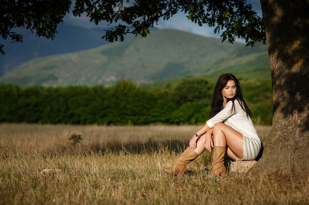 Liberty peace of mind concept. Attractive young woman is walking in field. She is looking forward with slight smile.