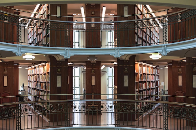 Photo library interior with bookshelves and stairs national library of finland