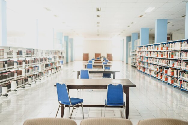 A library with blue chairs and a table with one that says " i'm not a library ".