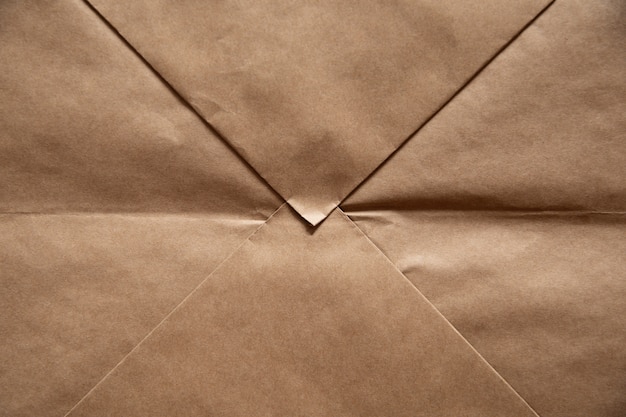 Licht bruine papieren achtergrond in de vorm van ambachtelijke envelop.