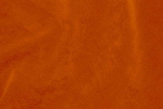 licht oranje fluweel stof textuur gebruikt als achtergrond zijde kleur saffraan stof achtergrond van zacht en glad textiel materiaal verpletterd fluweel luxe zon licht toon voor zijde