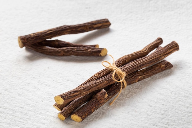 Licorice medicinal plant root on white background