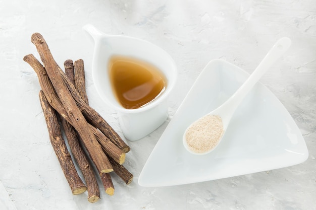 Licorice tea powder and roots on the table