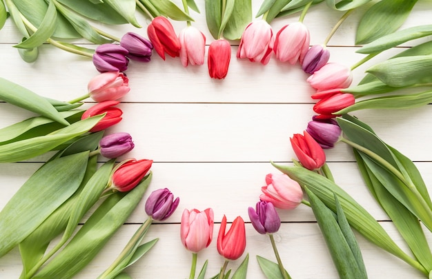 Liefde concept. Hartvorm gemaakt van tulpen Lentebloemen, kopieer ruimte binnen. Bovenaanzicht plat lag