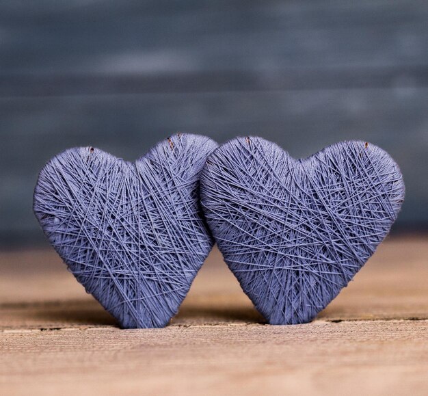 Liefde harten op houten textuur achtergrond Valentijnsdag kaart concept Oorspronkelijk gebreide hart