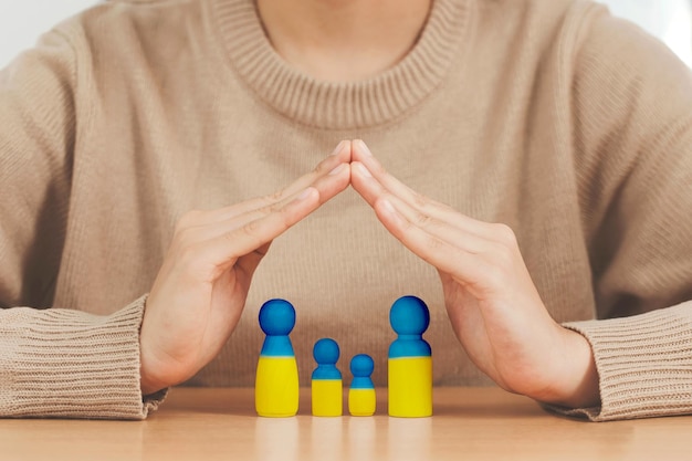 Liefde oekraïne concept vrouw handen beschermen familie in de vorm van een huis met familie