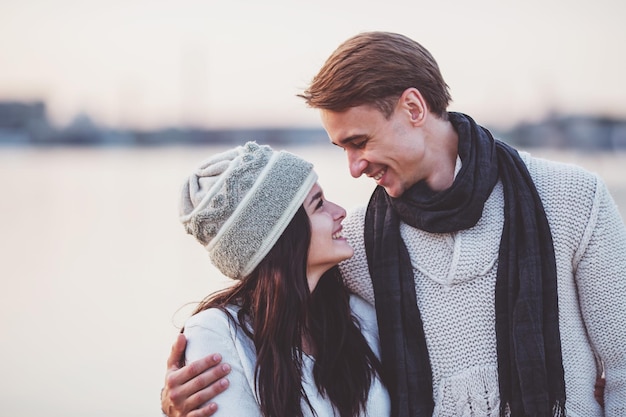 Liefdevol jong stel loopt in de herfst op het strand