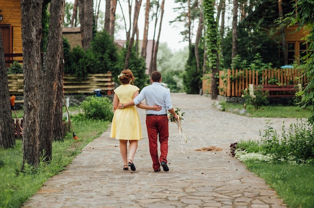 Liefhebbers houden elkaars hand vast en wandelen in het park