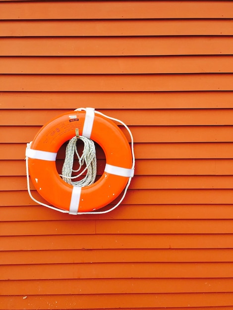 Life belt on wooden pattered wall