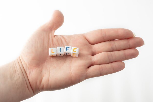 Photo life concept word from cubes in human hand