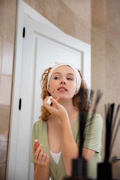 Photo life at home with young adult cleaning her face