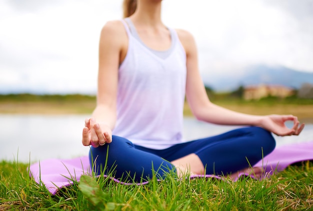 Life is a balance of holding on and letting go Shot of a young woman doing yoga outdoors