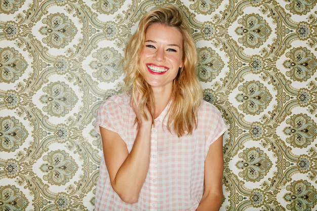 Life is better when youre laughing Shot of a young woman posing against a wallpaper background