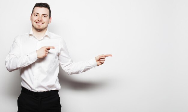 life style business and people concept business man points with fingers in the right side over white background