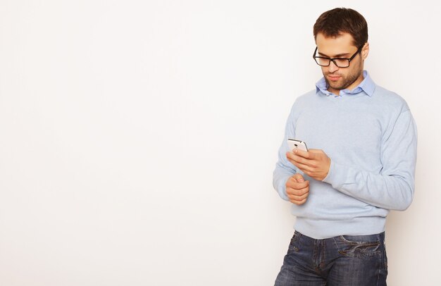 Life style, business and people concept: Young business man using mobile phone.Over white background.