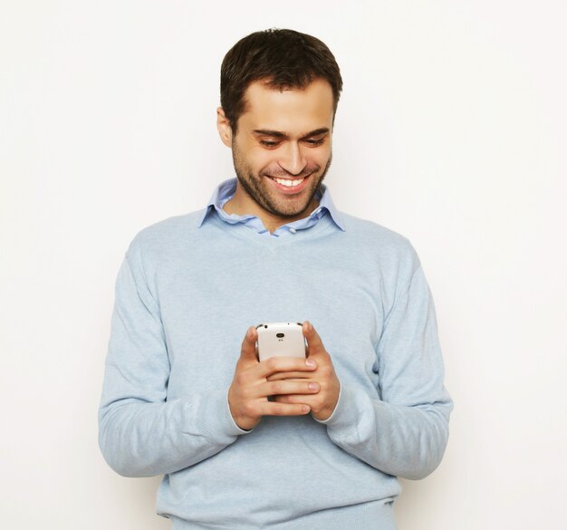 Life style, business and people concept: Young business man using mobile phone.Over white background.