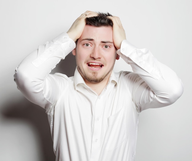 Life style, business  and people concept: young office worker mad by stress screaming isolated on white