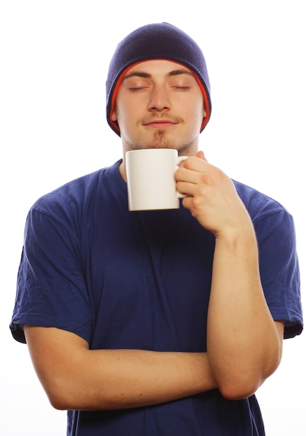 Life style, food  and people concept: casual young man holding white cup with coffee or tea.