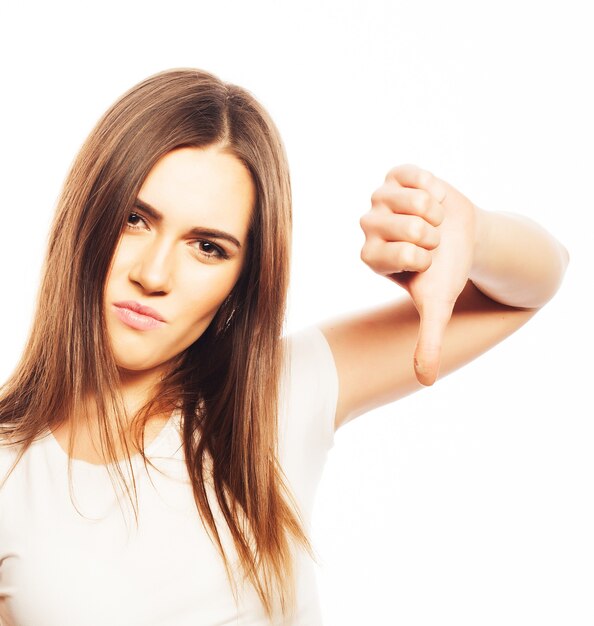 Life style, happiness, emotional  and people concept: Beautiful young  woman wearing white shirt looking at camera and make different emotions while standing against white background